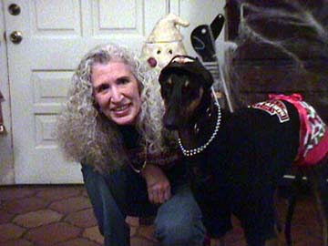 Maya, black Greyhound, and Charlotte dressed for a party in black t-shirts, silver necklaces and red miniskirts.