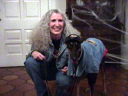 Maya, black Greyhound, and Charlotte dressed in Harley jackets and silver necklaces.